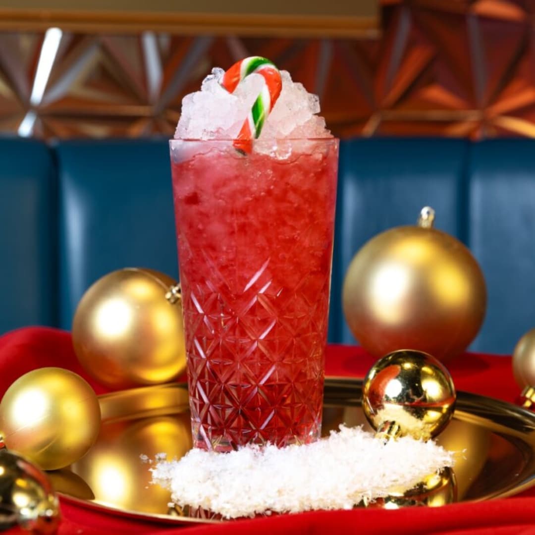 Red cocktail with candy cane